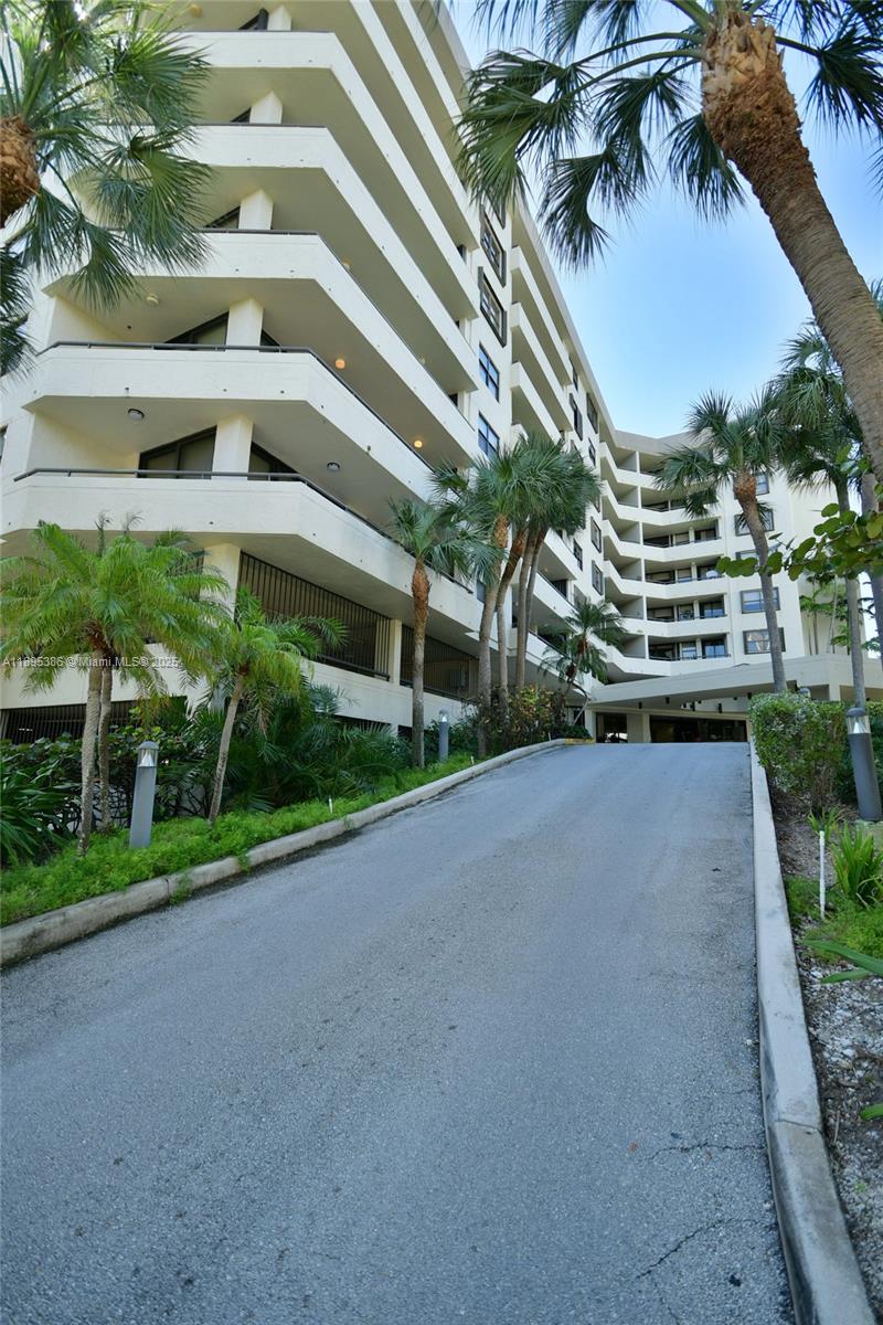 170 Ocean Ln Drive, Unit 311 Key Biscayne, FL 33149 - Photo 31 of 32 a view of a tall building next to a yard