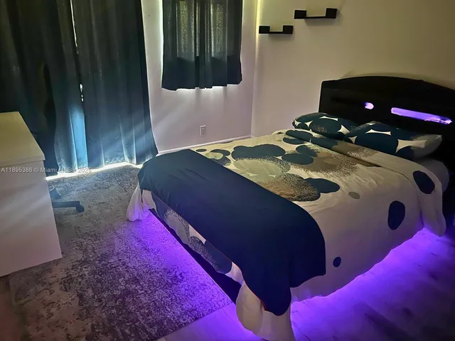 a bedroom with a bed and a small yard