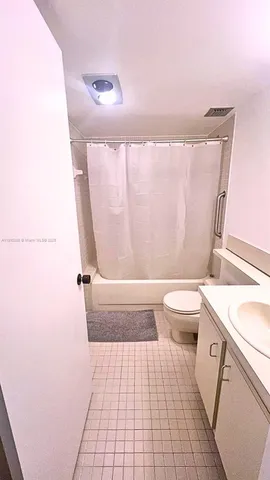 a bathroom with a sink a toilet and a shower