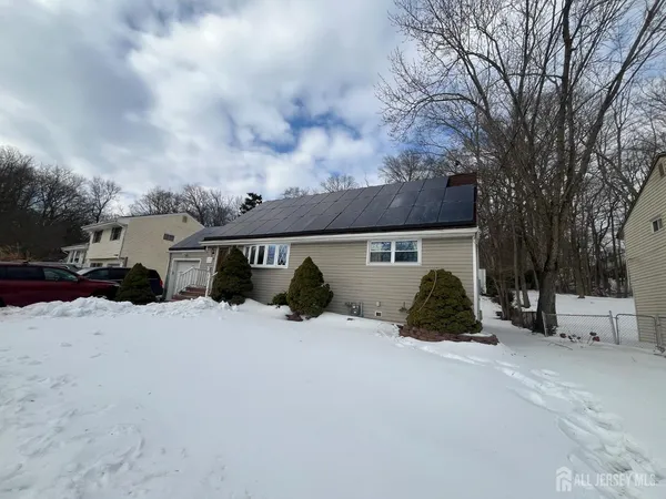 a view of a house with a yard covered with snow in front of house