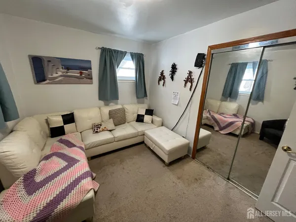 a living room with furniture and a mirror