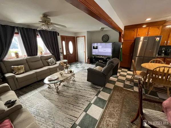 a living room filled with furniture and a flat screen tv
