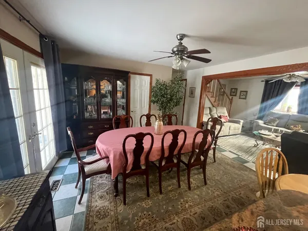 a dining room with furniture a chandelier and window