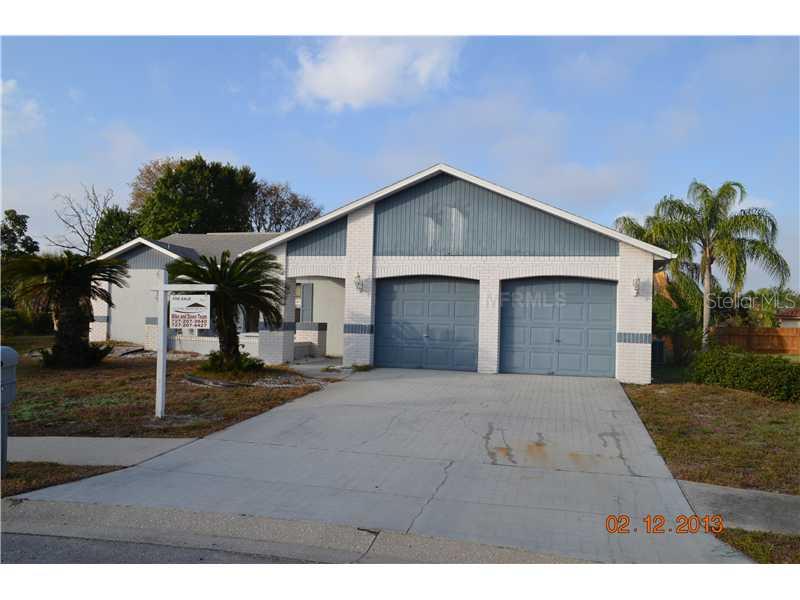 7314 Royal Crescent Court Port Richey, FL 34668 - Photo 1 of 1 a front view of a house with a yard and garage