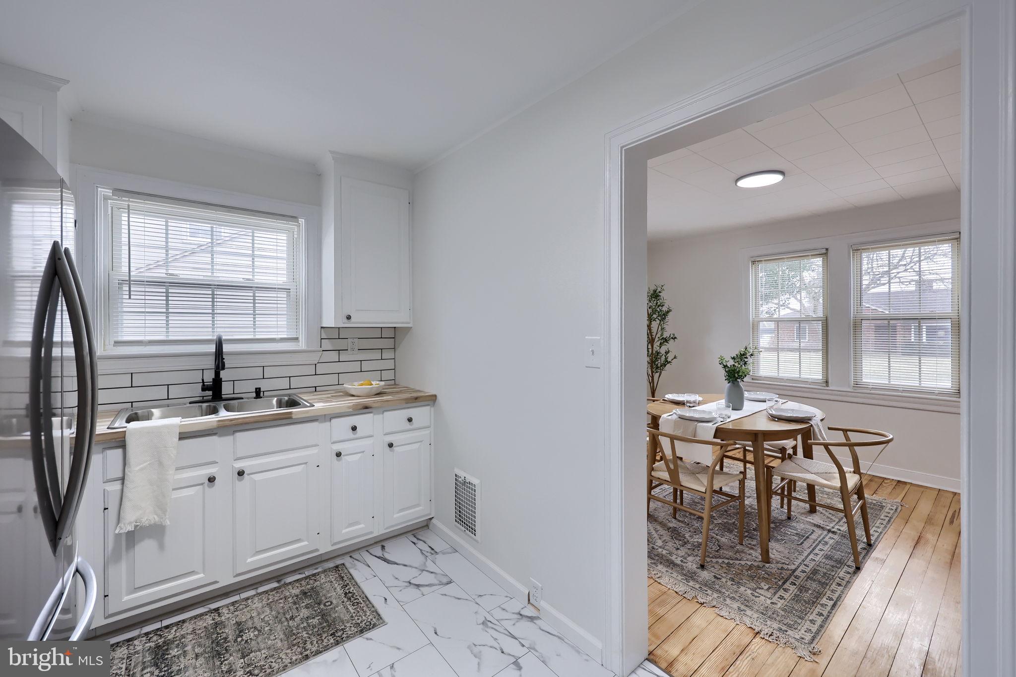 1297 Graystone Road Manheim, PA 17545 - Photo 11 of 29 a kitchen with granite countertop a sink dining table and chairs