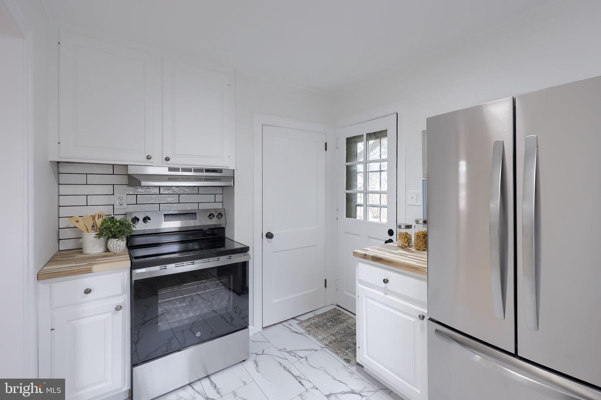 1297 Graystone Road Manheim, PA 17545 - Photo 12 of 29 a kitchen with a stove and white cabinets