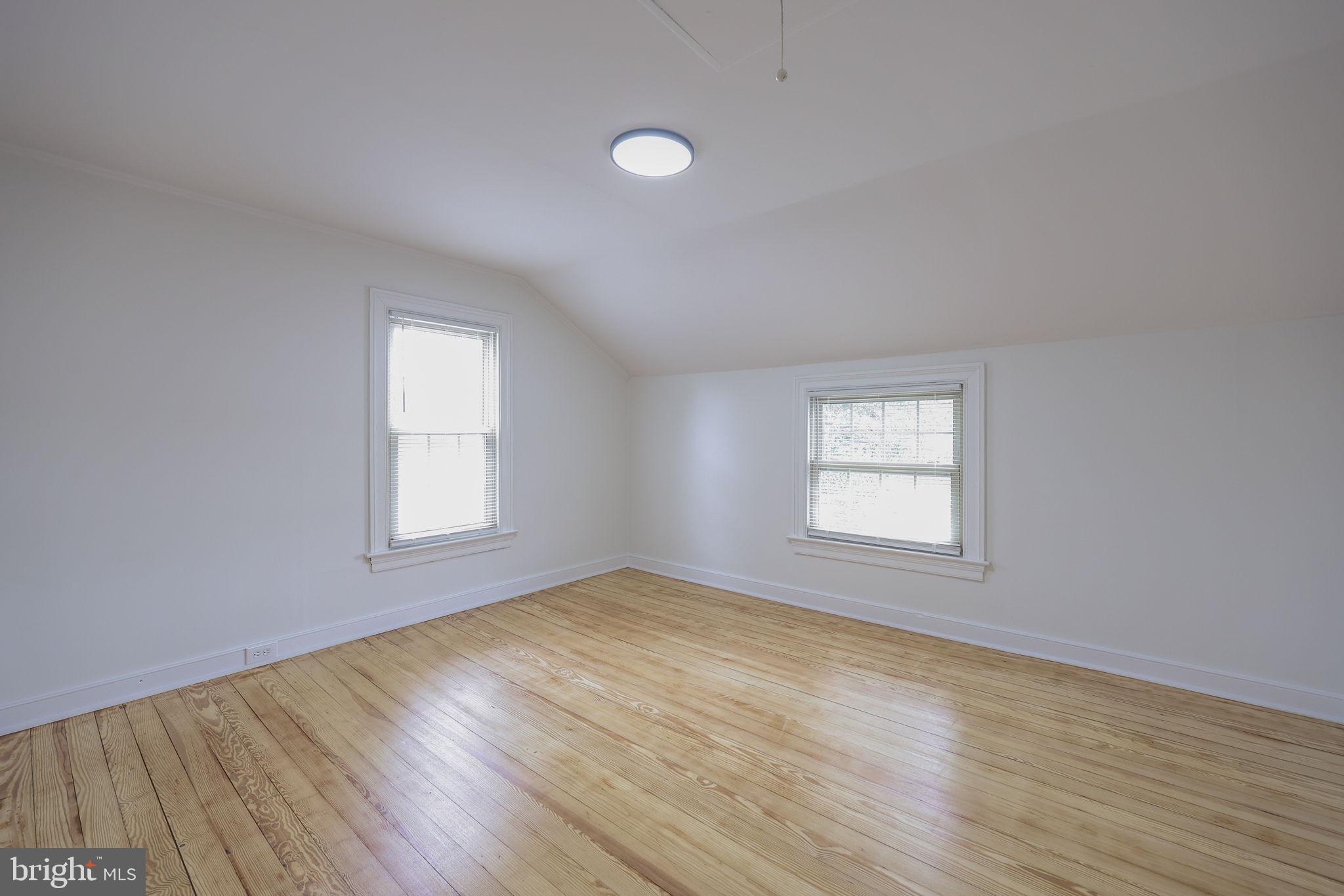 1297 Graystone Road Manheim, PA 17545 - Photo 18 of 29 an empty room with wooden floor and windows
