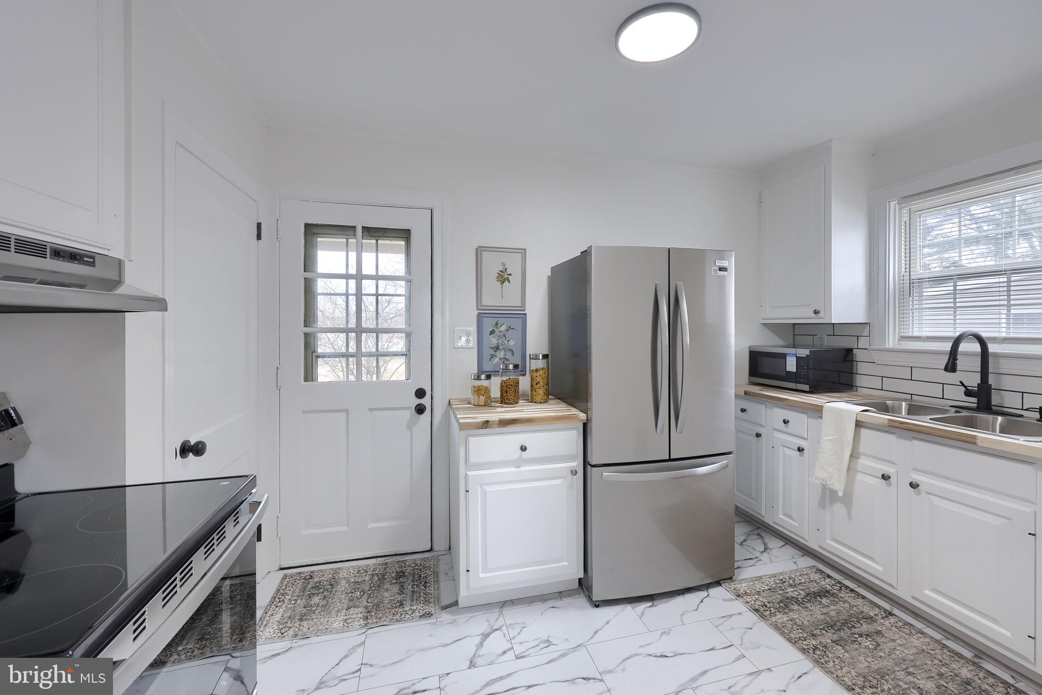 1297 Graystone Road Manheim, PA 17545 - Photo 10 of 29 a kitchen with a refrigerator sink and cabinets