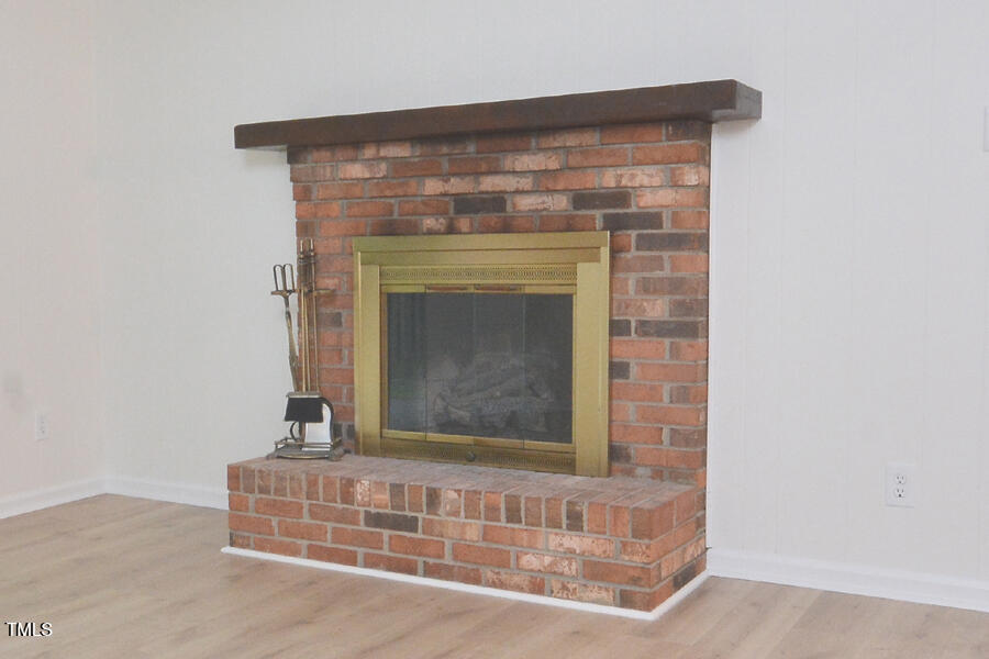 5825 Scalybark Road Durham, NC 27712 - Photo 8 of 44 a view of fireplace with wooden floor