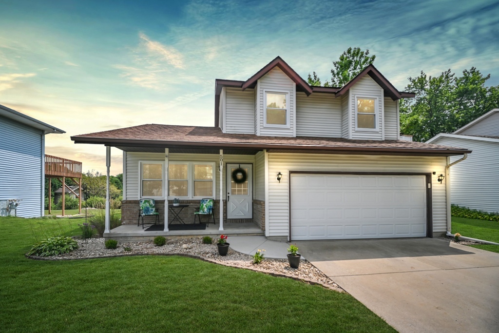 501 Carriage Hills Road Normal, IL 61761 - Photo 1 of 77 a front view of a house with a garden and plants