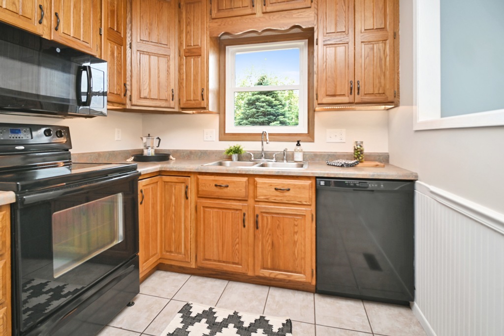501 Carriage Hills Road Normal, IL 61761 - Photo 13 of 77 a kitchen with stainless steel appliances granite countertop a sink stove and cabinets
