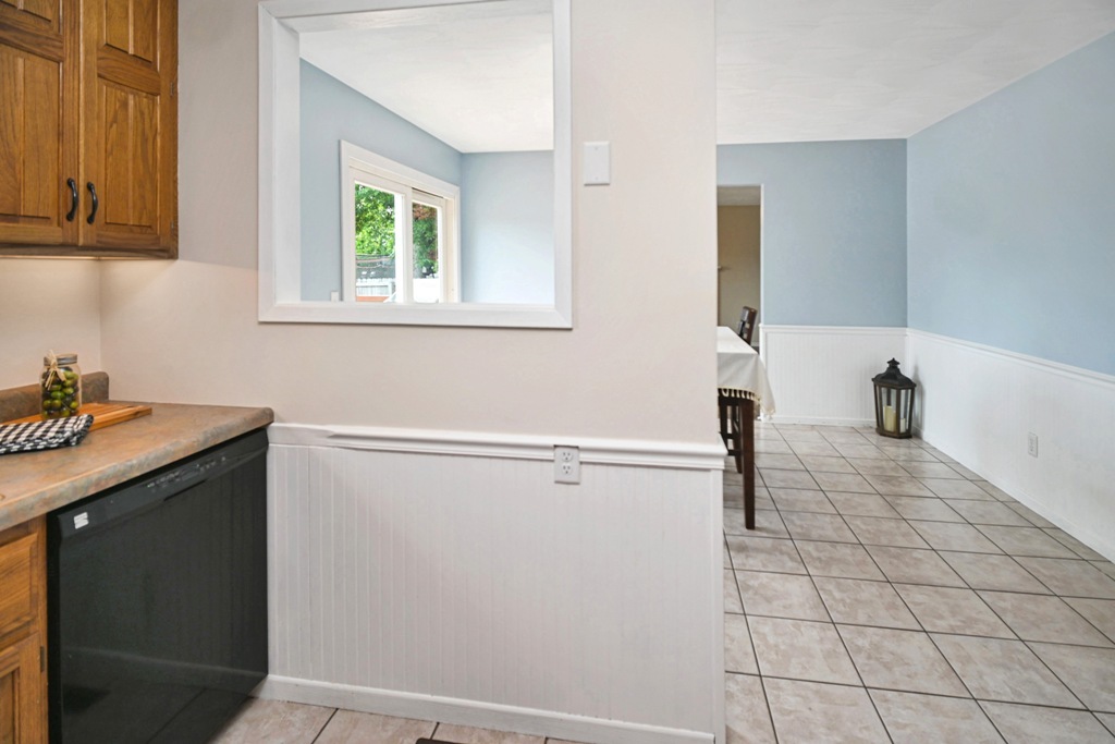 501 Carriage Hills Road Normal, IL 61761 - Photo 15 of 77 a view of a kitchen with white cabinets and a window