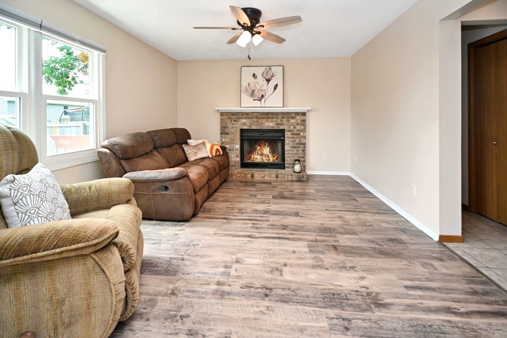 501 Carriage Hills Road Normal, IL 61761 - Photo 17 of 77 a living room with furniture a large window and a fireplace