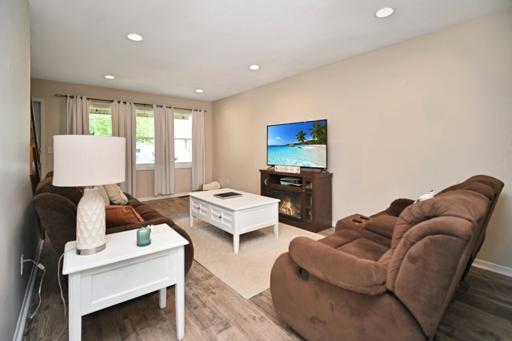 501 Carriage Hills Road Normal, IL 61761 - Photo 32 of 77 a living room with furniture a window and a flat screen tv