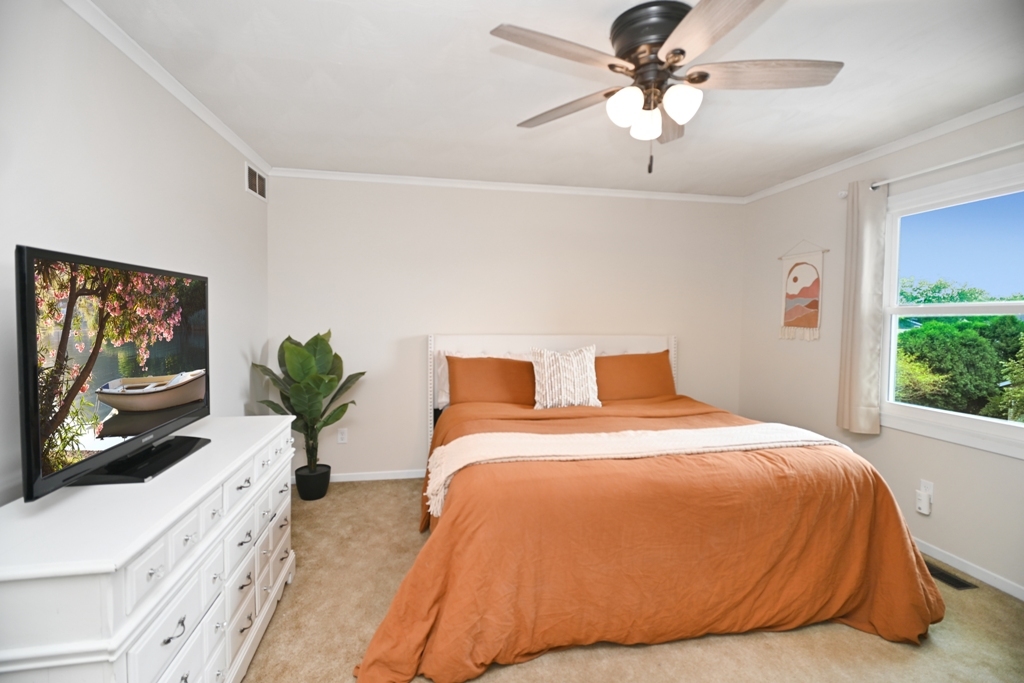 501 Carriage Hills Road Normal, IL 61761 - Photo 34 of 77 a spacious bedroom with a bed and a flat screen tv