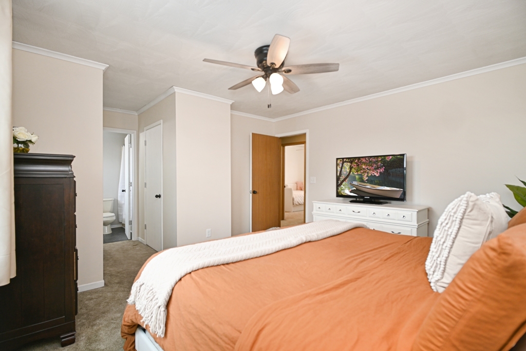 501 Carriage Hills Road Normal, IL 61761 - Photo 37 of 77 a bedroom with a bed and a flat screen tv