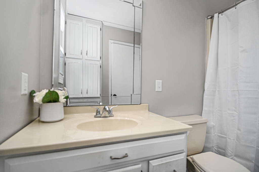 501 Carriage Hills Road Normal, IL 61761 - Photo 40 of 77 a bathroom with a sink and a mirror with toilet