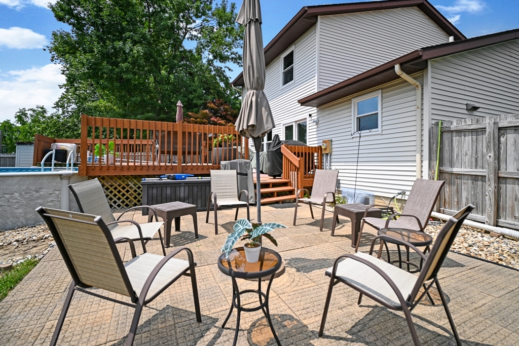 501 Carriage Hills Road Normal, IL 61761 - Photo 67 of 77 a view of a patio with table and chairs with wooden floor and fence