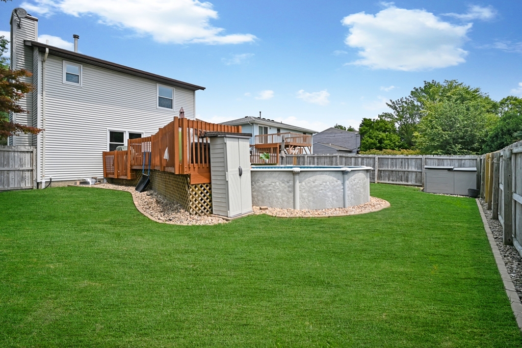501 Carriage Hills Road Normal, IL 61761 - Photo 69 of 77 a view of a house with a yard deck and a patio