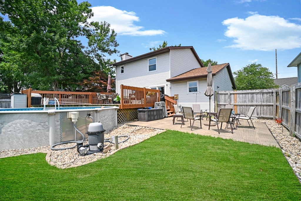 501 Carriage Hills Road Normal, IL 61761 - Photo 73 of 77 a view of a patio with table and chairs potted plants and large tree