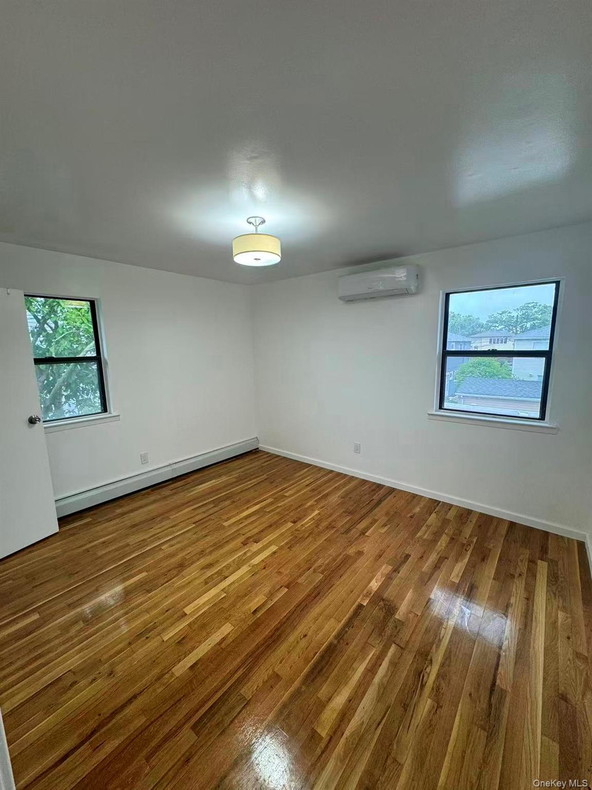 376 Newbridge Road East Meadow, NY 11554 - Photo 5 of 7 a view of empty room with wooden floor