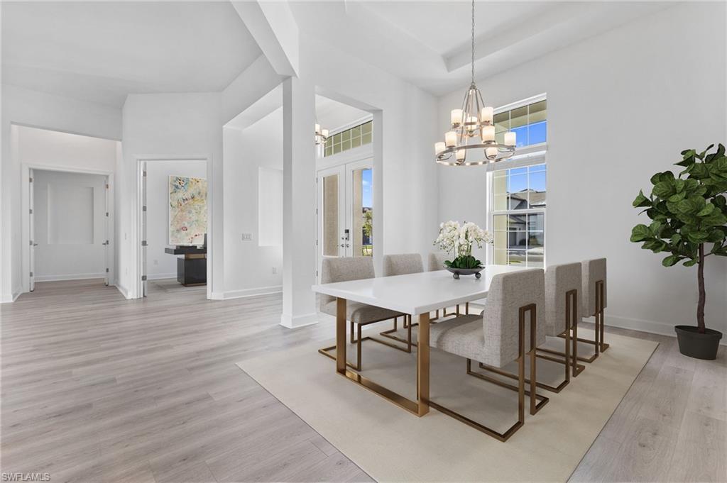 15564 Montello Lane Naples, FL 34114 - Photo 20 of 49 a view of a dining room with furniture and chandelier