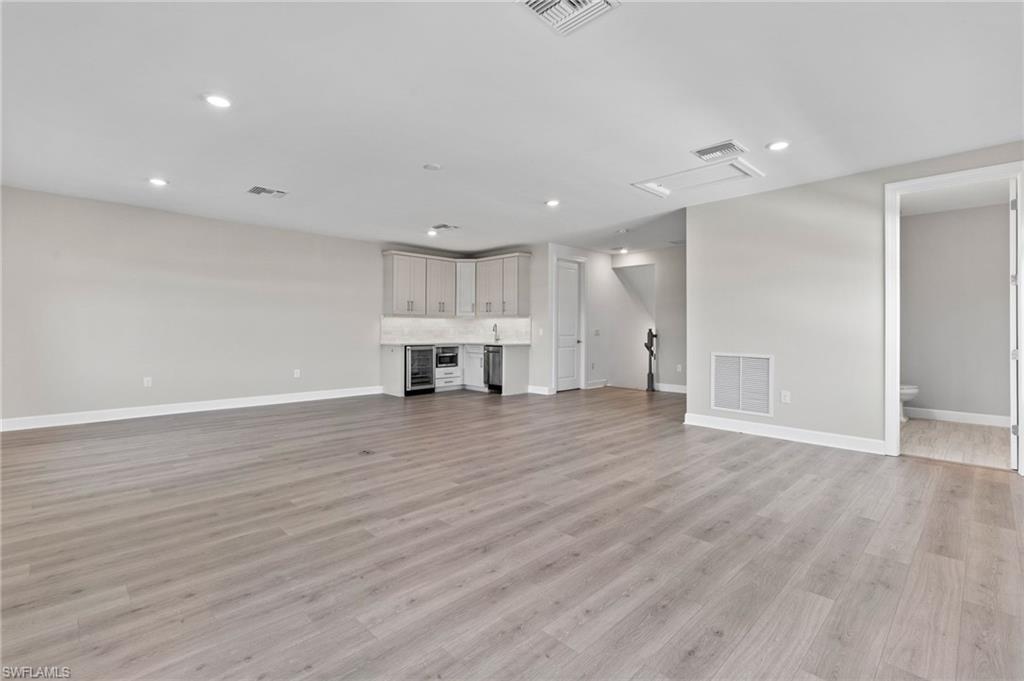 15564 Montello Lane Naples, FL 34114 - Photo 23 of 49 a view of empty room with wooden floor