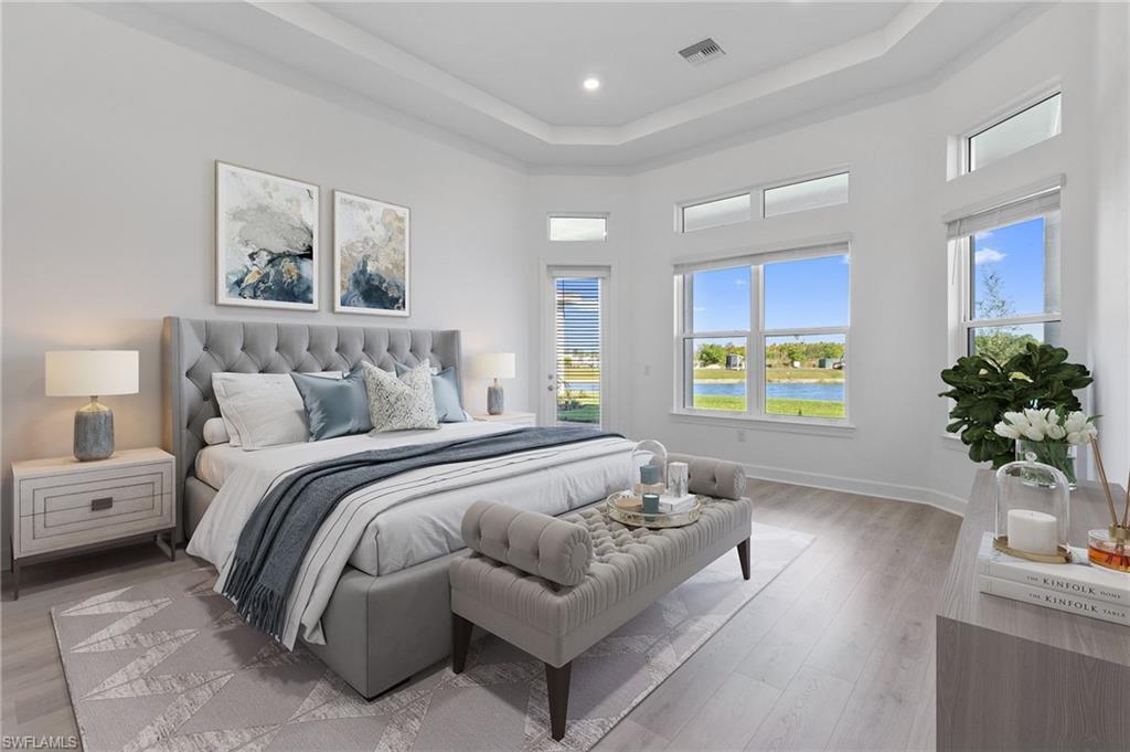 15564 Montello Lane Naples, FL 34114 - Photo 26 of 49 a bedroom with bed and a couch