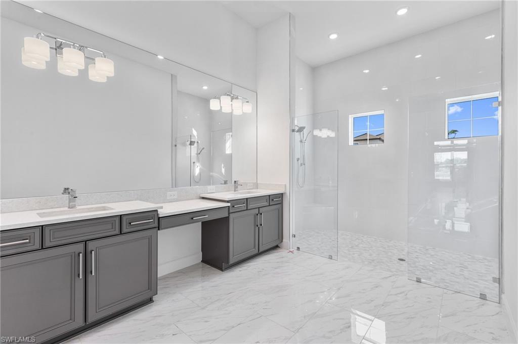 15564 Montello Lane Naples, FL 34114 - Photo 29 of 49 a large bathroom with a sink mirror and a shower