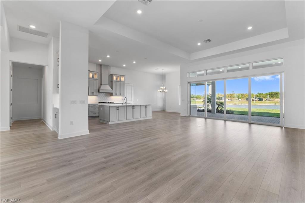 15564 Montello Lane Naples, FL 34114 - Photo 3 of 49 a view of a kitchen with a sink and a large window