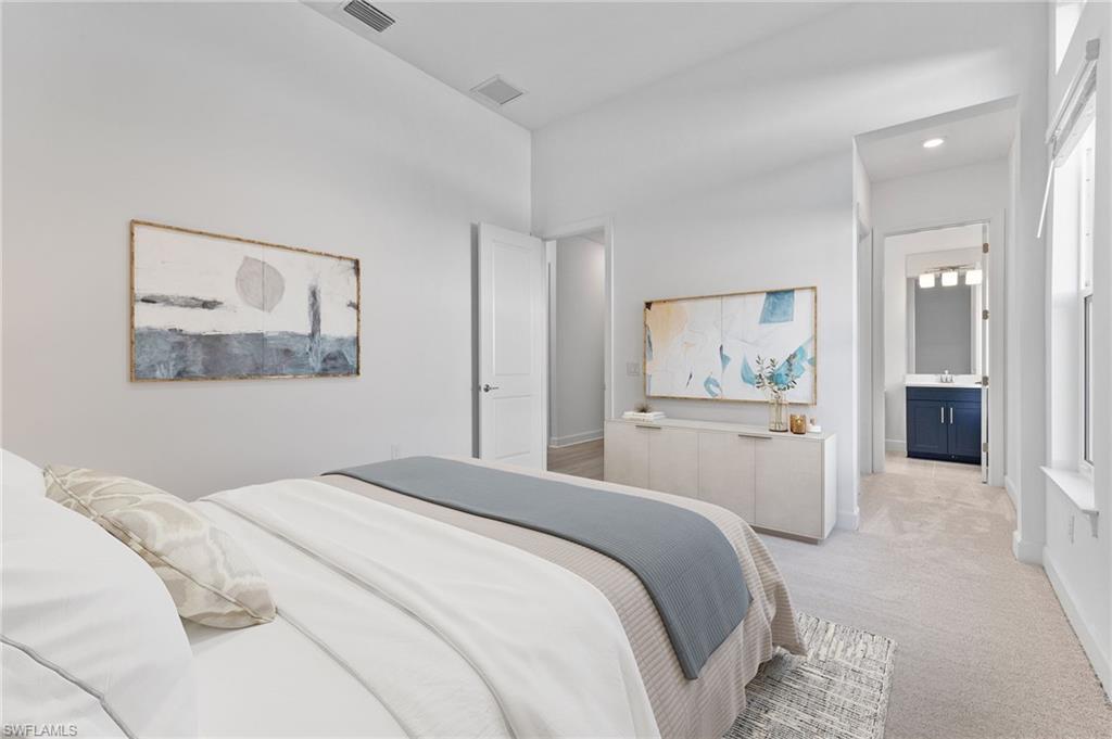 15564 Montello Lane Naples, FL 34114 - Photo 32 of 49 a bedroom with a large bed and painting on the wall