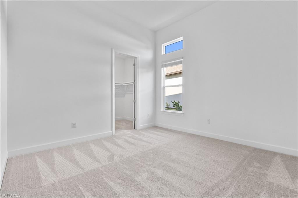15564 Montello Lane Naples, FL 34114 - Photo 36 of 49 an empty room with windows