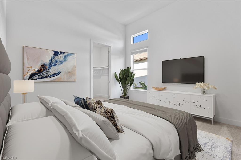 15564 Montello Lane Naples, FL 34114 - Photo 37 of 49 a bedroom with a bed and a flat screen tv