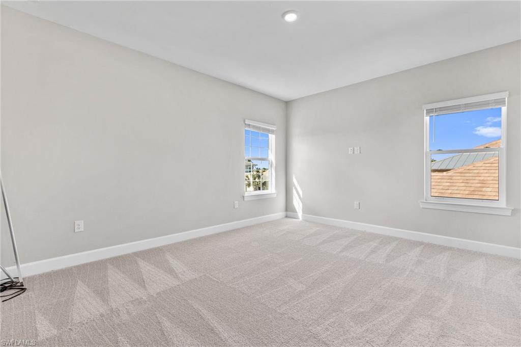 15564 Montello Lane Naples, FL 34114 - Photo 39 of 49 a view of an empty room with a window