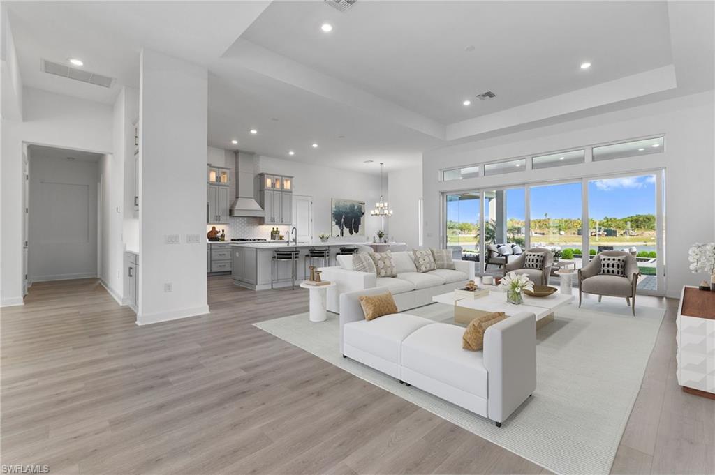 15564 Montello Lane Naples, FL 34114 - Photo 4 of 49 a living room with furniture and a large window