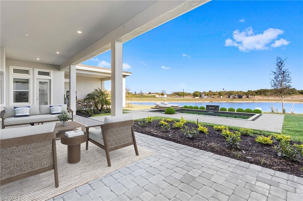 15564 Montello Lane Naples, FL 34114 - Photo 45 of 49 a view of a patio with furniture and a garden