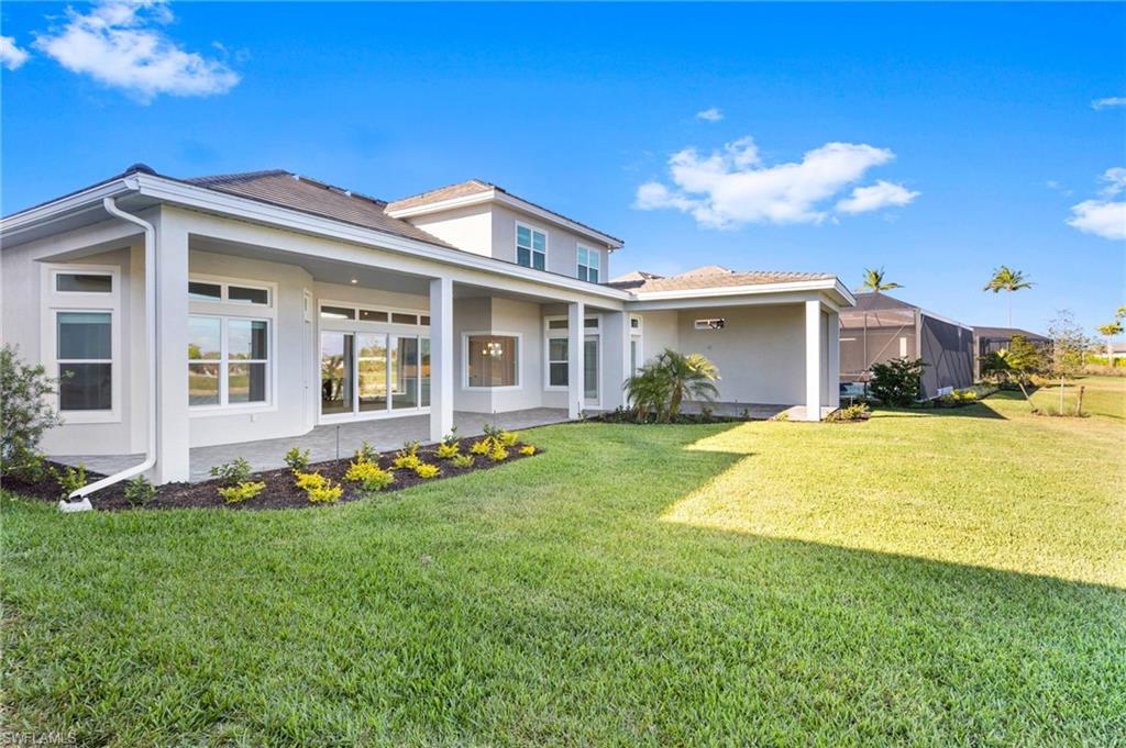 15564 Montello Lane Naples, FL 34114 - Photo 47 of 49 a front view of a house with a yard