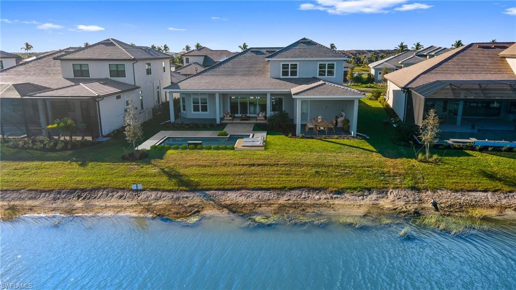 15564 Montello Lane Naples, FL 34114 - Photo 48 of 49 a front view of a house with a yard