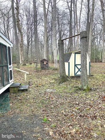 a backyard of a house with barbeque oven table and chairs
