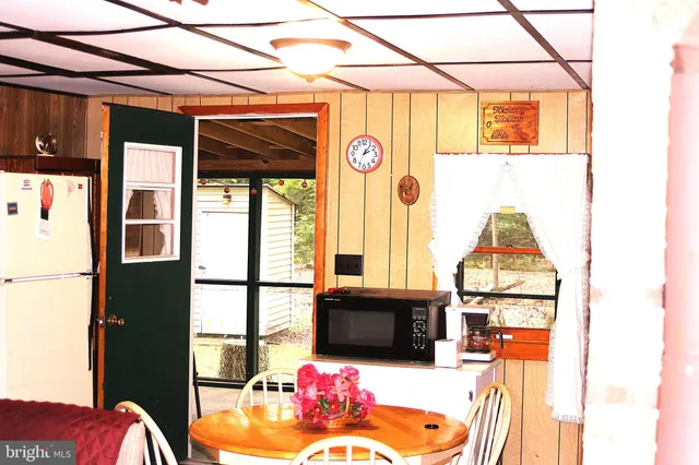 a living room with furniture a flat screen tv and a table