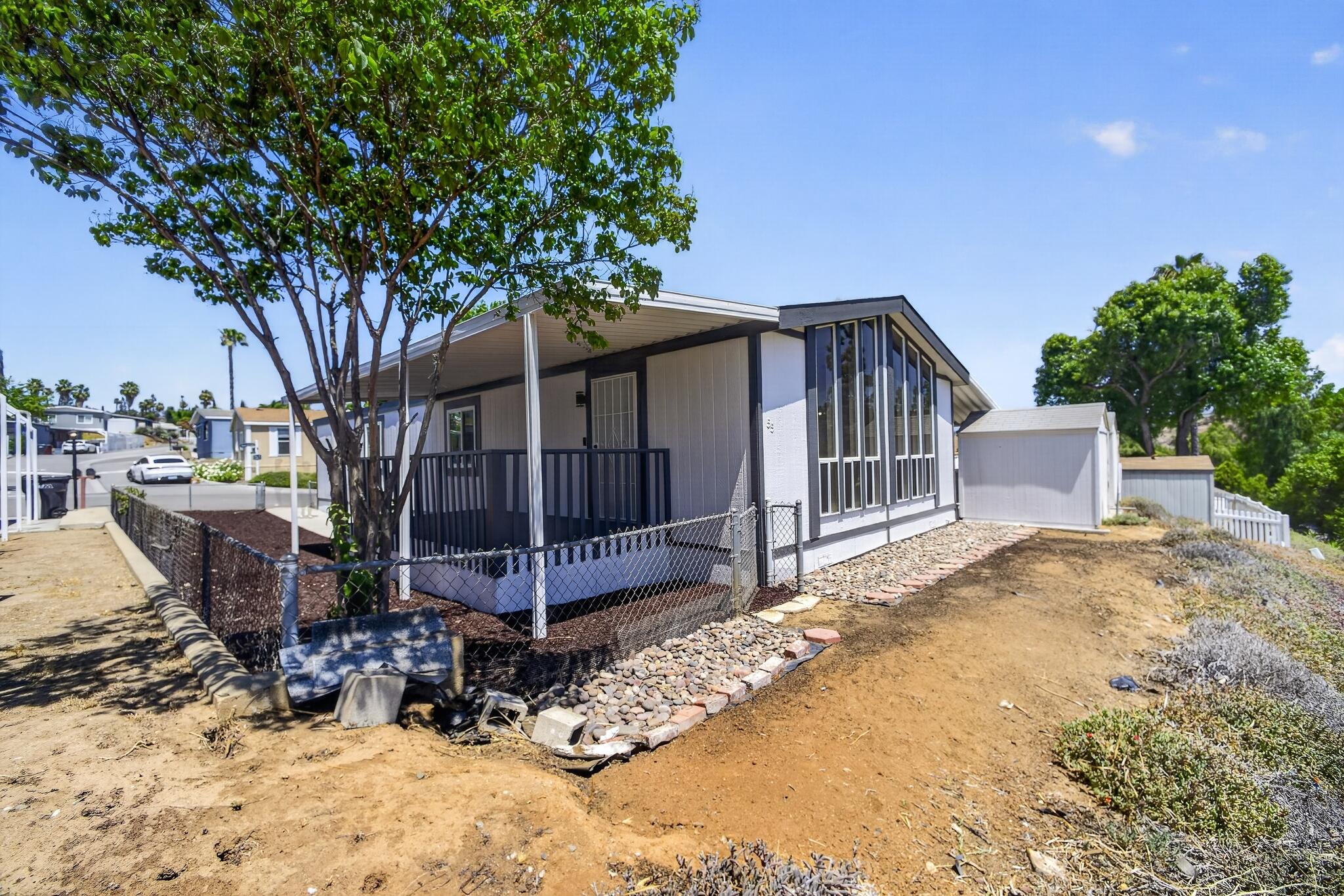 15181 Van Buren Boulevard, Unit 102 Riverside, CA 92504 - Photo 2 of 29 a view of a house with a yard covered in snow