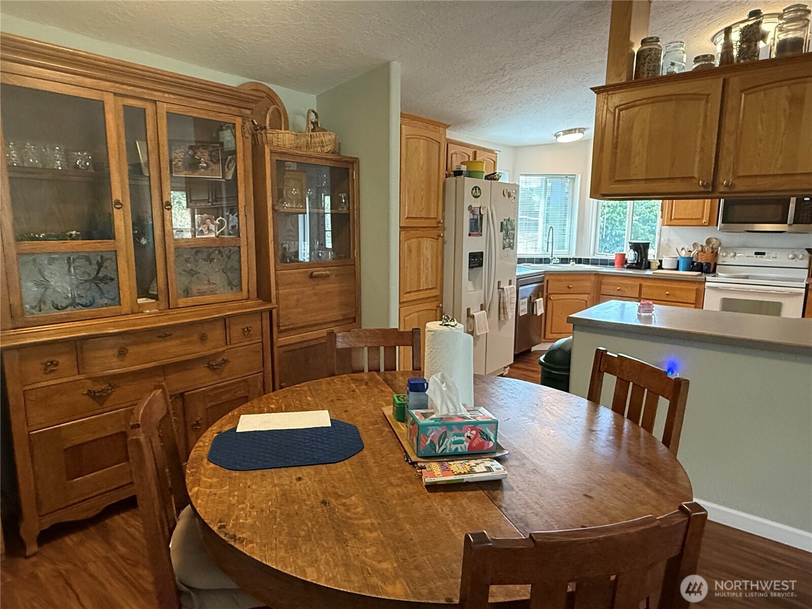 1934 Tucannon Road Pomeroy, WA 99347 - Photo 8 of 40 a kitchen with a table chairs and flat screen tv