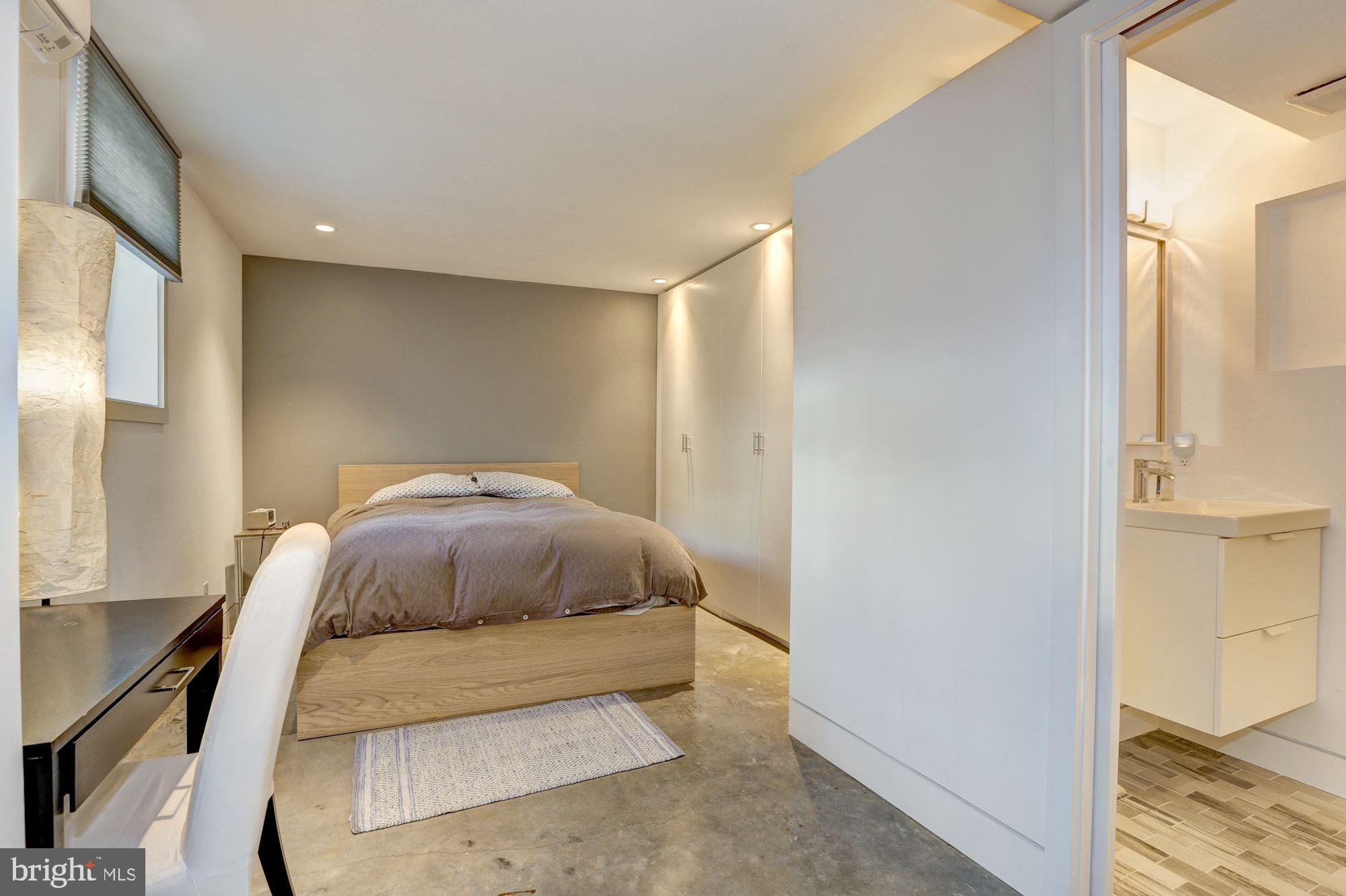 400 U Street Northwest, Unit LL Washington, DC 20001 - Photo 5 of 10 a spacious bedroom with a bed and wooden floor