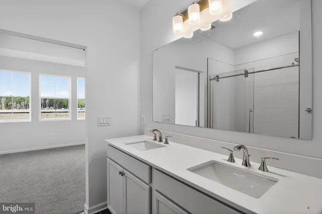 a bathroom with a sink vanity granite and a mirror