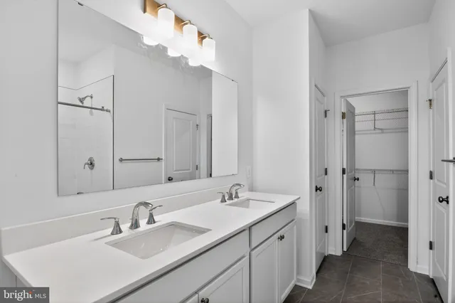 a bathroom with a sink double vanity granite tub and shower