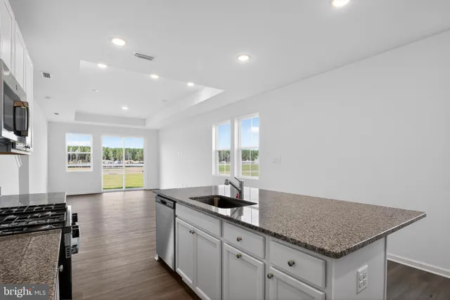 a kitchen with sink cabinets and wooden floor