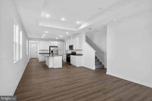 a view of kitchen with wooden floor and electronic appliances