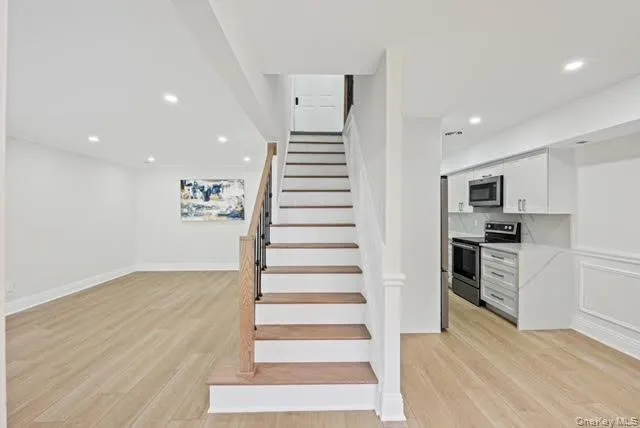 a view of a kitchen with wooden floor and electronic appliances