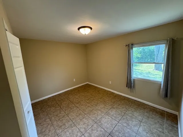 an empty room with a empty space and a window