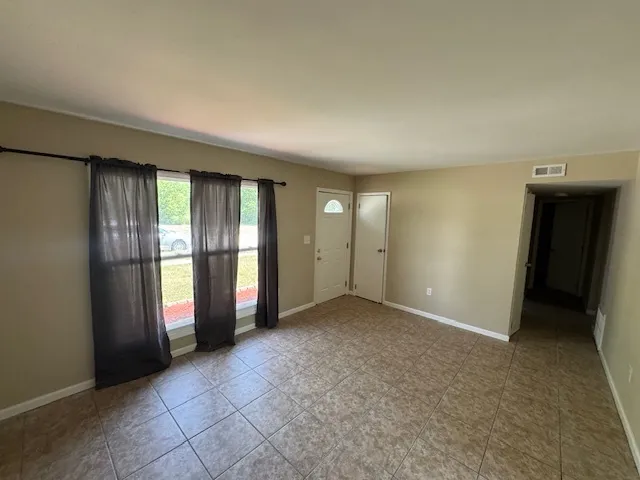 an empty room with closet and mirror